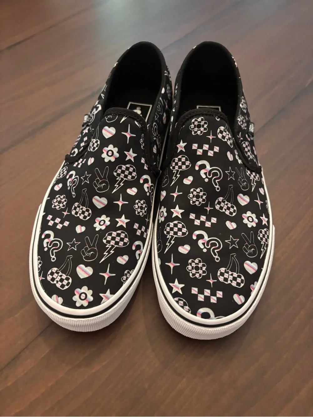 Vans Women’s Black Slip-On Sneakers with Multicolor Icon Accents